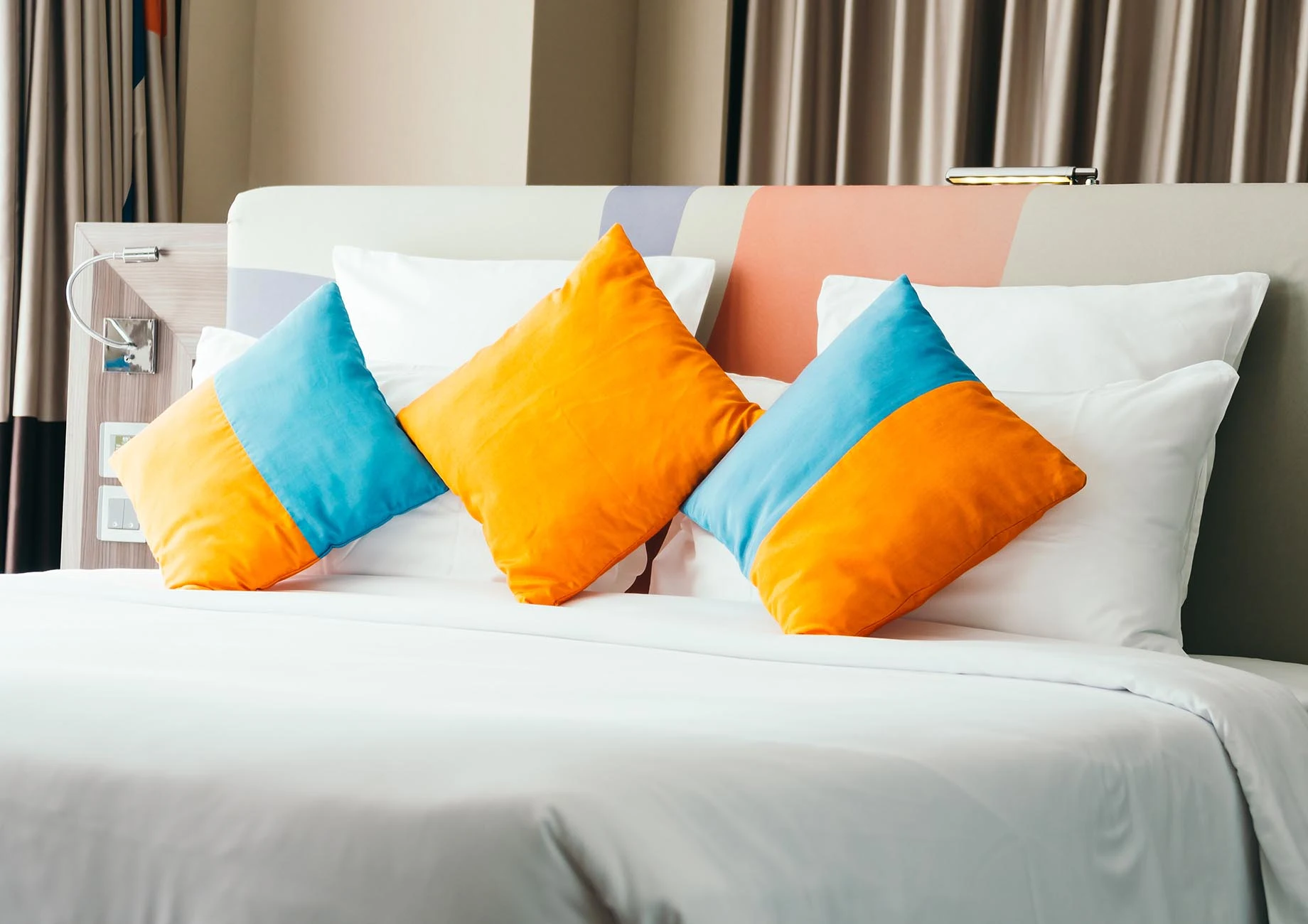 Layered cotton sateen pillows with scalloped shams